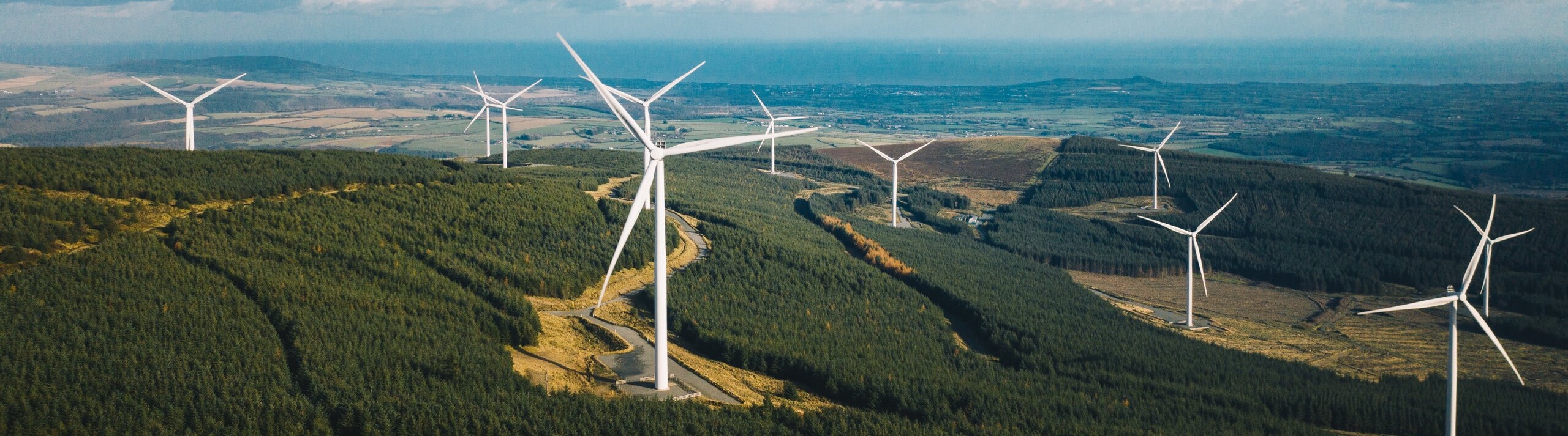 Wind farm across green hills